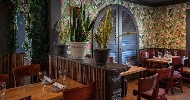 Interior, tables with tableware and glasses