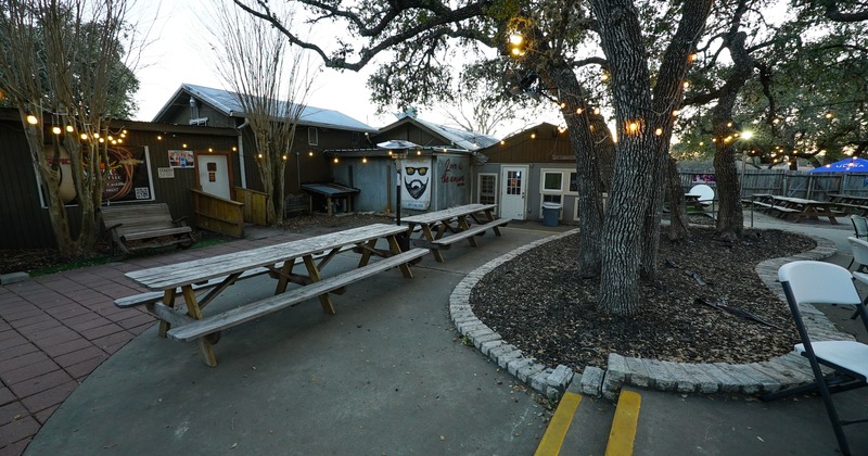 Wooden picnic tables by the tree