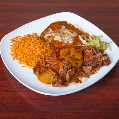 Steak Ranchero servd with rice, beans and lettuce.
