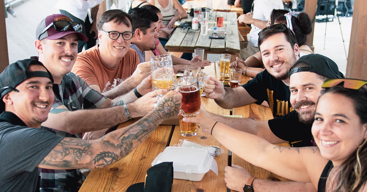 Lots of people toasting with their drinks