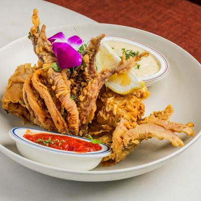 Crispy fried calamari tentacles served with dipping sauces.