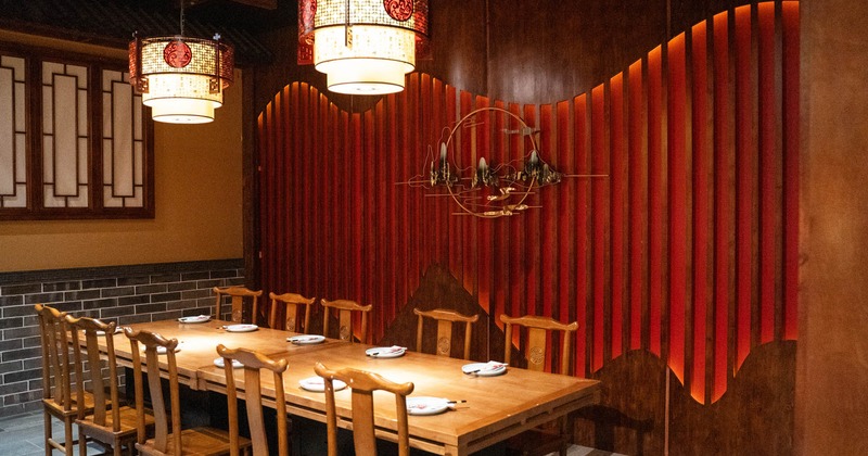 Interior, long wooden table setup for ten, wooden chairs, Chinese style lanterns