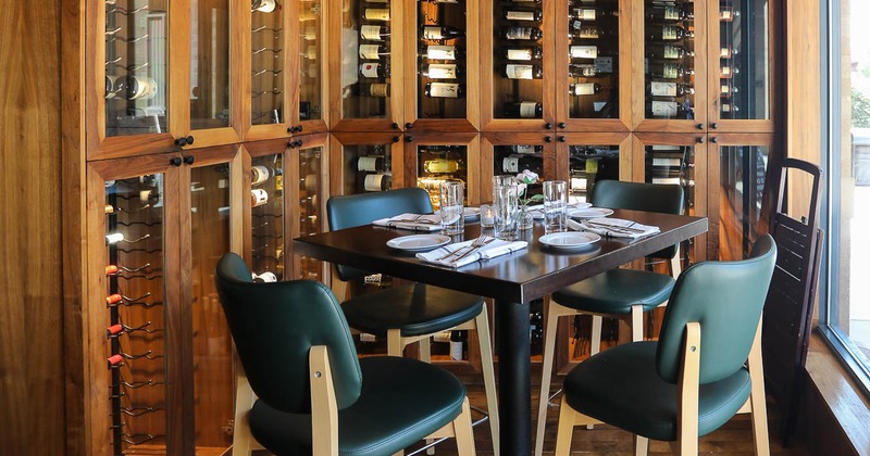 Interior, table and chairs near wine rack