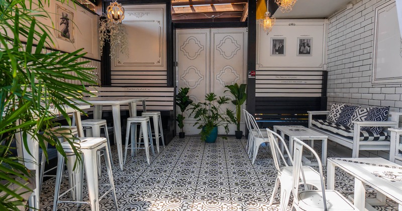 Exterior, covered high and regular seating area, tile flooring with complex patterns