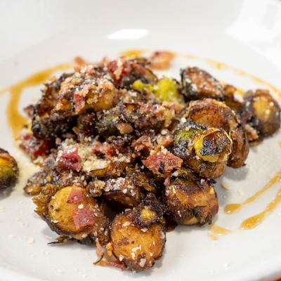 Fried Brussels sprouts with bacon, Parmesan, and maple bourbon glaze.