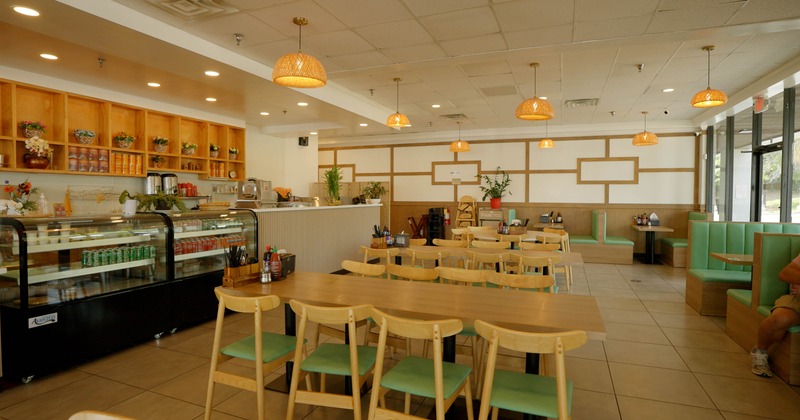 Interior - wooden tables & chairs, a glass display case, decorative shelving, hanging lights