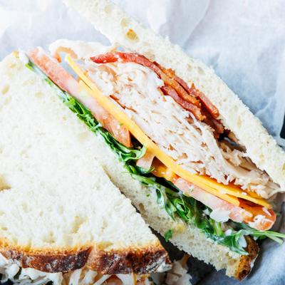 Turkey and Bacon sandwich with cheddar, arugula, tomato and mayo.