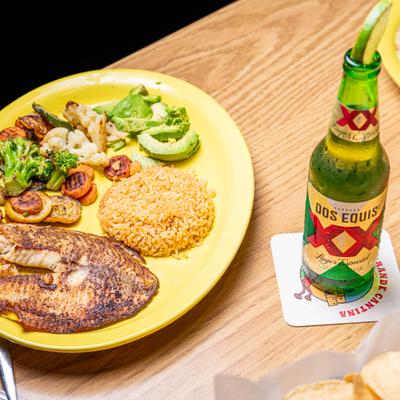 grilled seasoned tilapia rice seasoned veggies and avacado slices.