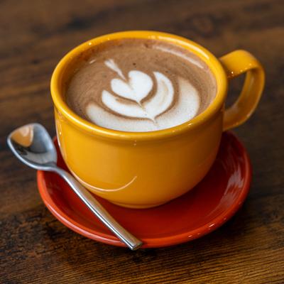 A cup of latte with leaf art.