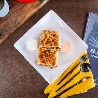 Grilled burrito cut in half, served with sour cream and a spicy dipping sauce.