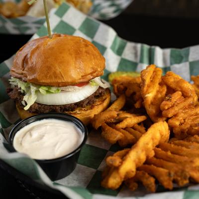 California Burger with dipping sauce and waffle fries on the side.