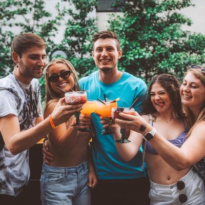 Outside, guests making a toast with cocktails