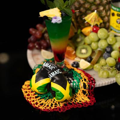 Bob Marley cocktail drink with fruits on a platter.
