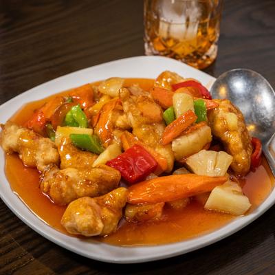 Sweet and Sour Chicken with pineapple, onion, carrots and bell peppers.