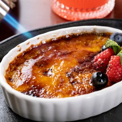 Creme brulee topped with fresh berries and a mint spring.