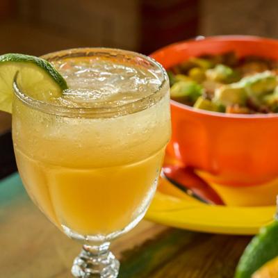 Margarita cocktail with lime garnish and salted rim.