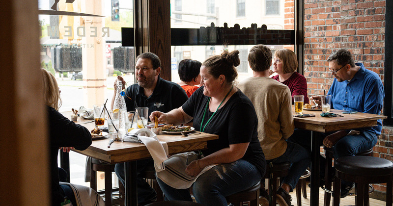 Guests sitting at tables enjoying their food and drinks