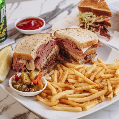 Served sandwiches with dips and fries.