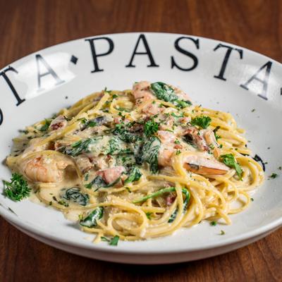 Creamy pasta with shrimp, spinach, and bacon.