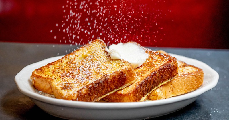 French toast topped with butter and dusting of powdered sugar