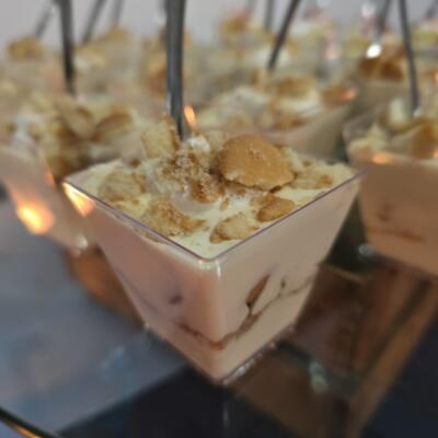 A creamy dessert in a cup, topped with crushed cookies.