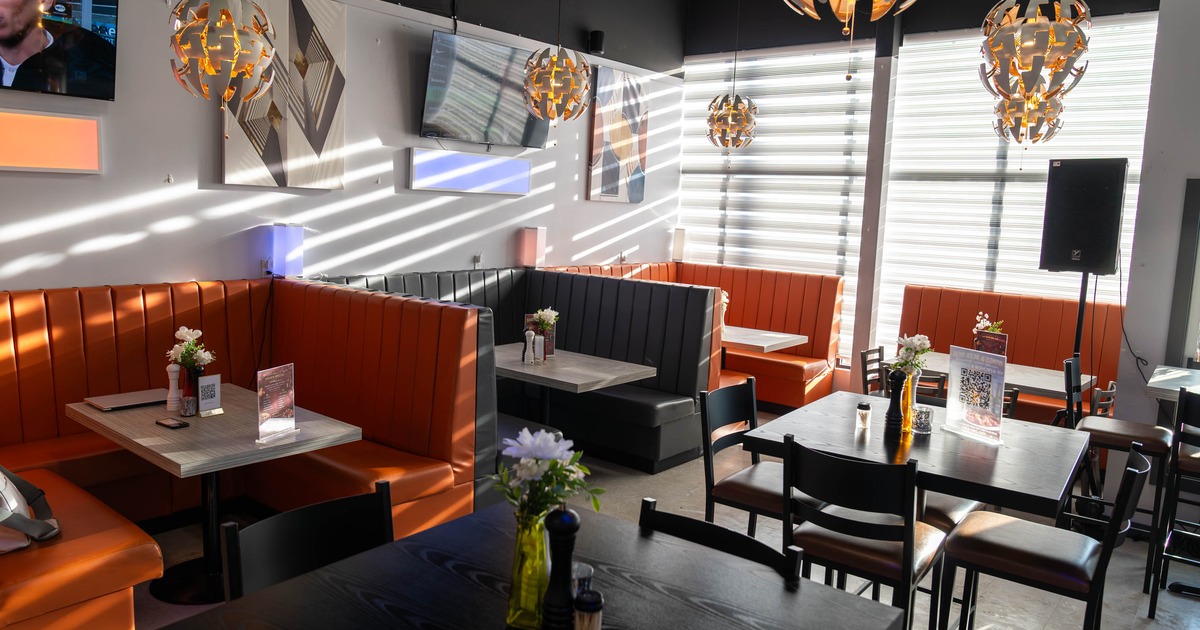 Interior seating area with booths, chairs and tables, wall decoration