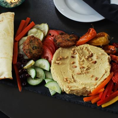 Hummus, veggies, falafel, and bread.