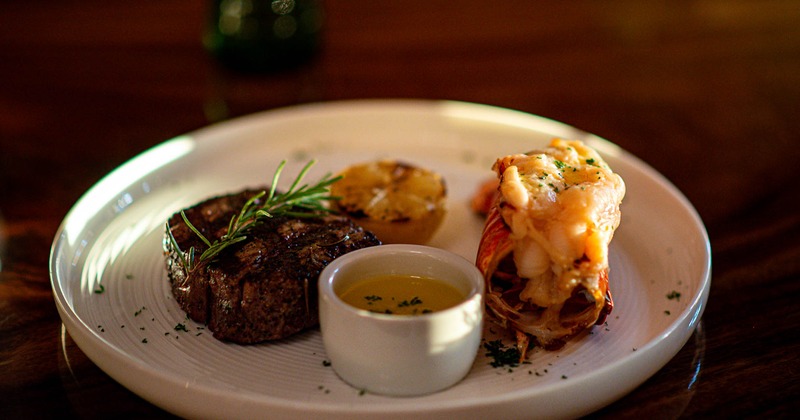 Fillet mignion and lobster tail served with butter and lemon
