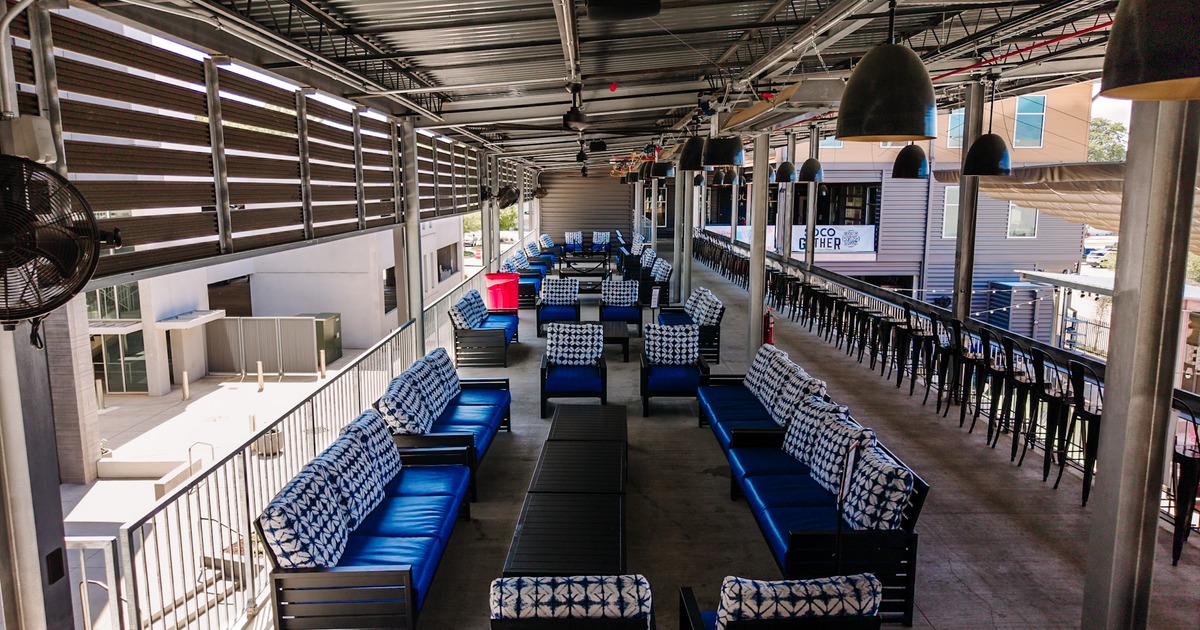 Covered rooftop seating area above the storefronts
