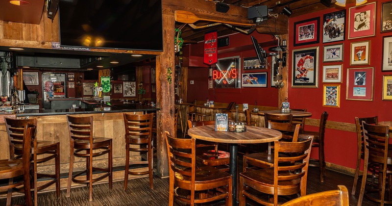 Interior, seating area with bar tables and stools and bar