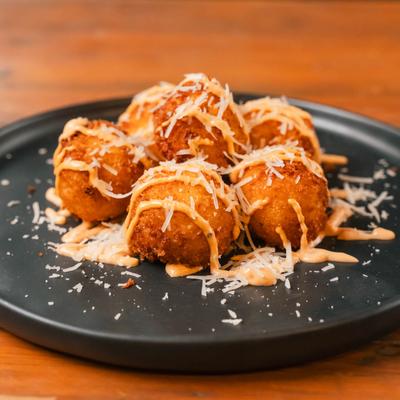 Fried Italian rice balls, stuffed with cheese.