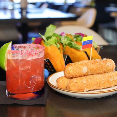 Bread dough sticks stuffed with white cheese, and a watermelon Margarita.