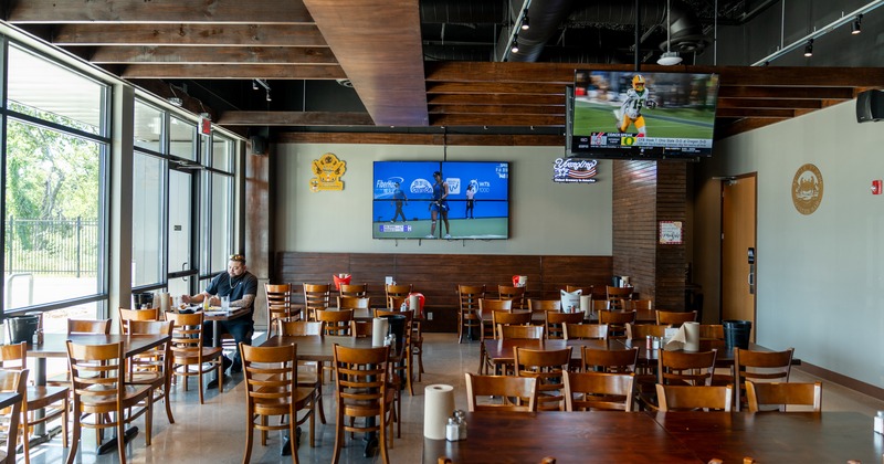 Diner room, tables, chairs, tv on the wall