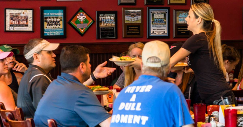 Staff member serving food to customers