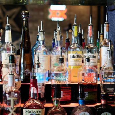 Various liquor bottles on the shelf.