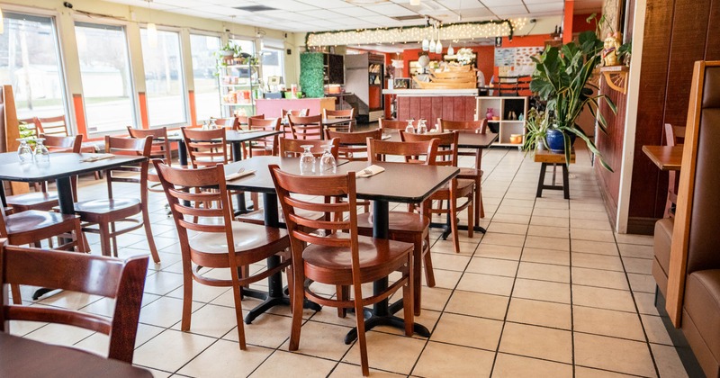 Casual restaurant interior with wooden tables and chairs