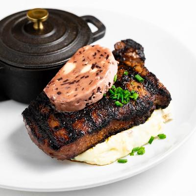 Grilled New York Strip steak, with mash and sausage