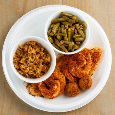 Grilled fish and shrimp served with rice, green beans and hush puppies.