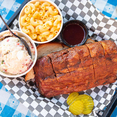 Meat loaf, salad, mac and cheese and bread combo.