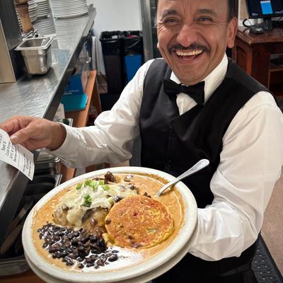 Restaurant employee carrying food.