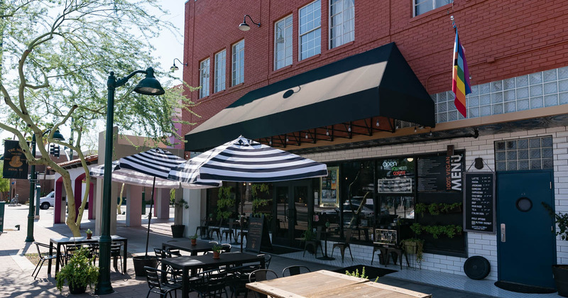 Outside seating area with blue and white patio umbrellas - side view