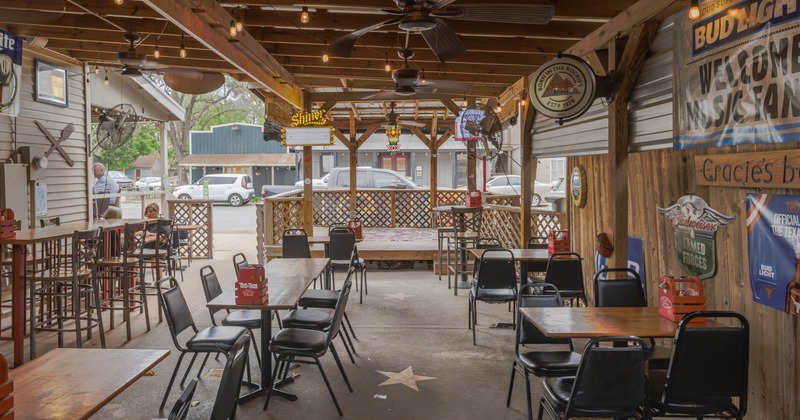 Exterior, covered seating area with tables and chairs