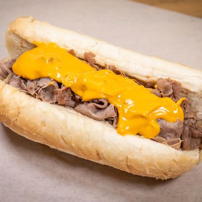 Italian beef sandwich smothered in cheddar cheese.