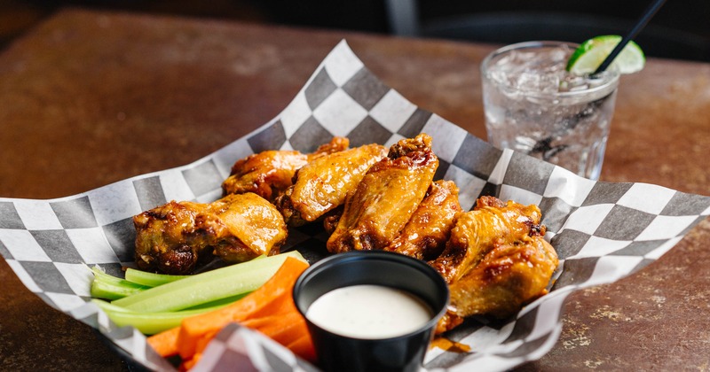 Chicken wings served with vegetable sticks and a dipping sauce