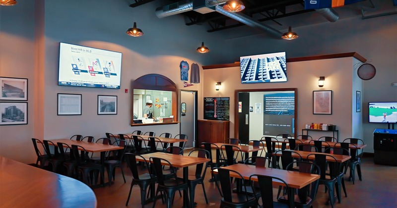 Interior, tables ready for guests, TVs on the walls