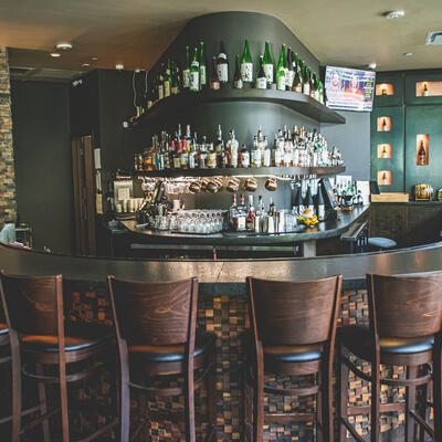 High chairs, bar area, shelves with drinks