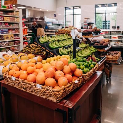 Store display featuring  baskets filled with fresh fruits.