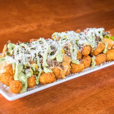 Loaded tater tots, with pulled brisket, jalapeno corn relish, cheese, and jalapeno cream.