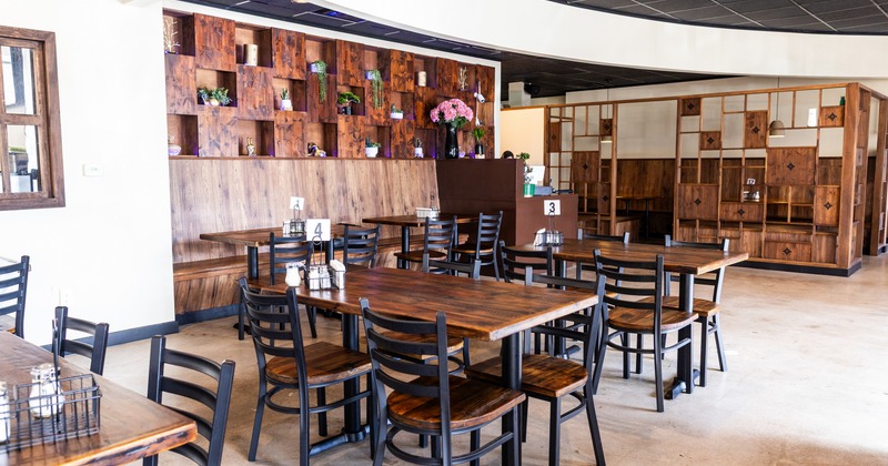 Interior, dining space with wooden tables and chairs