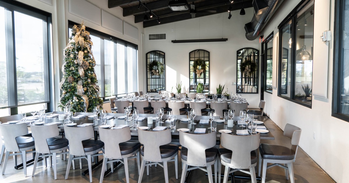 Banquet room set for celebration, decorated with a Christmas tree